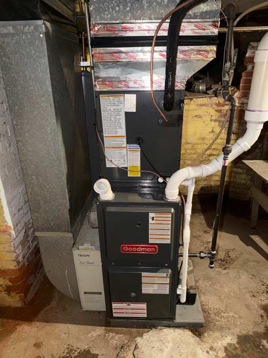 Technician inspecting an air conditioning unit for repair at a Minnesota home